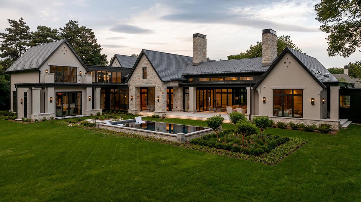 Rear elevation with twin chimneys and raised infinity pool at dusk
