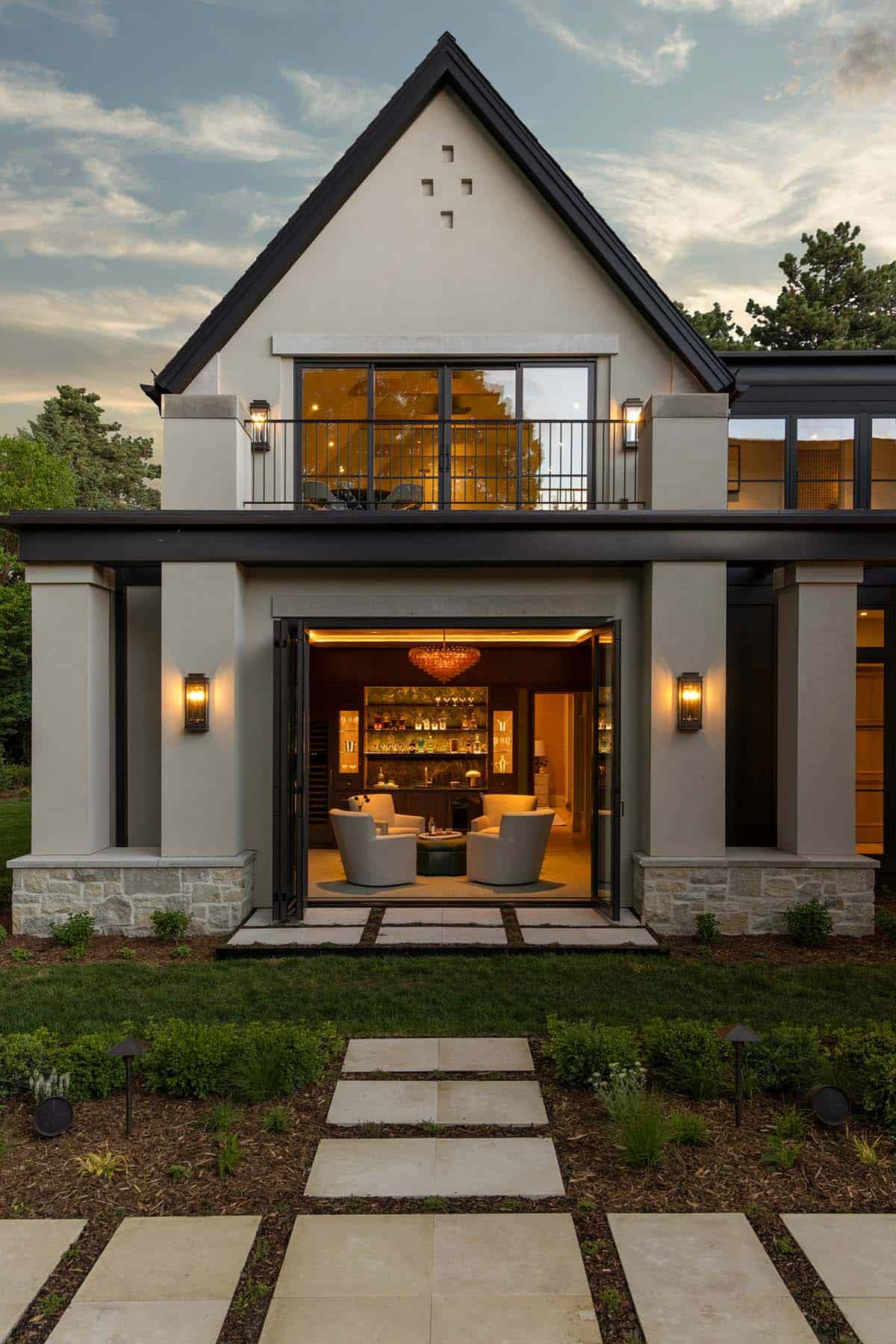 Second-story bar room framed by open black steel doors