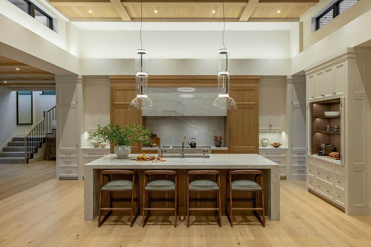 Kitchen island glowing warmly under pendant lights at dusk