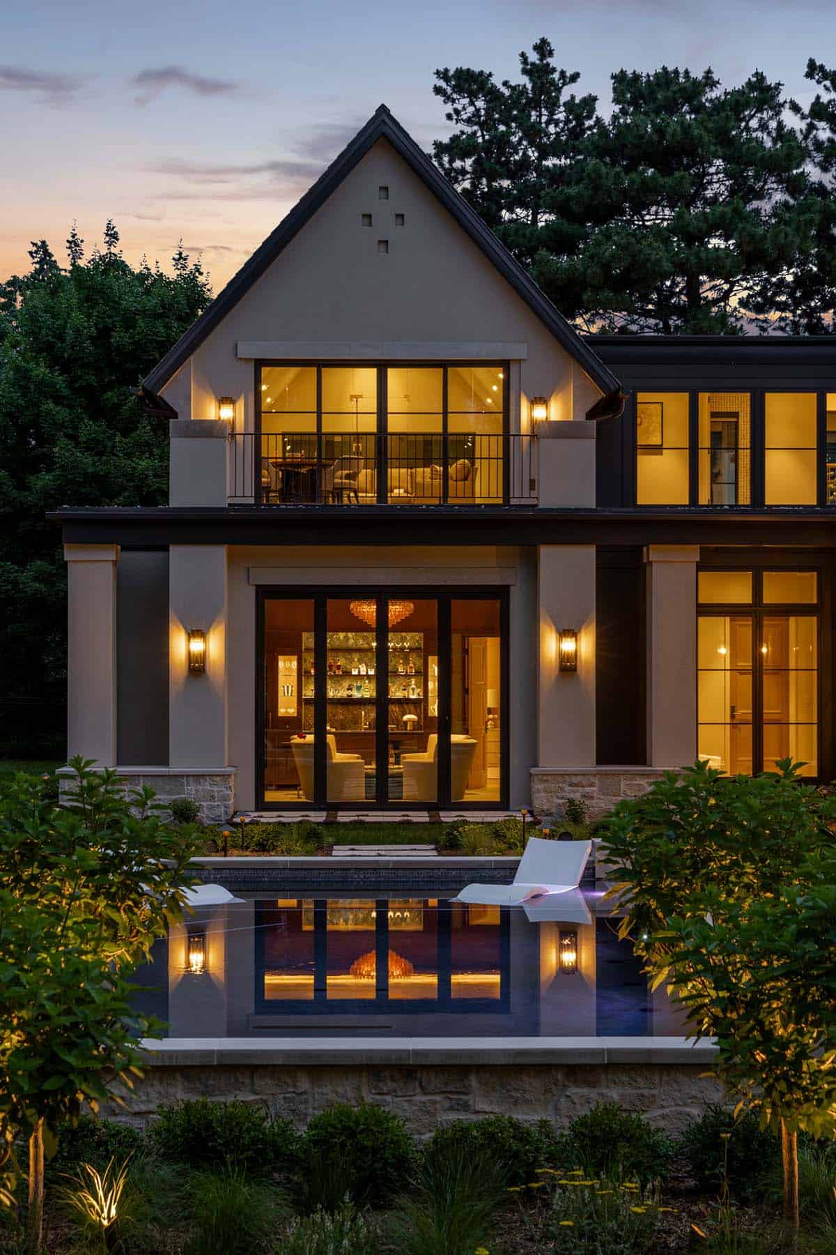 Gabled facade at twilight with lit bar room and pool