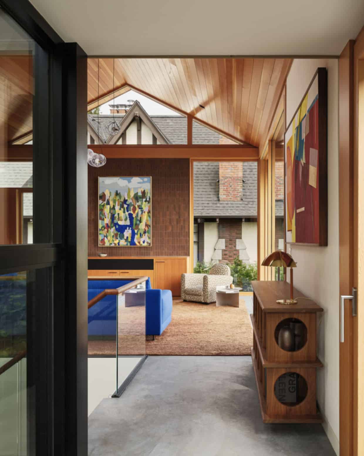 Vaulted living room framed by neighboring Tudor rooflines