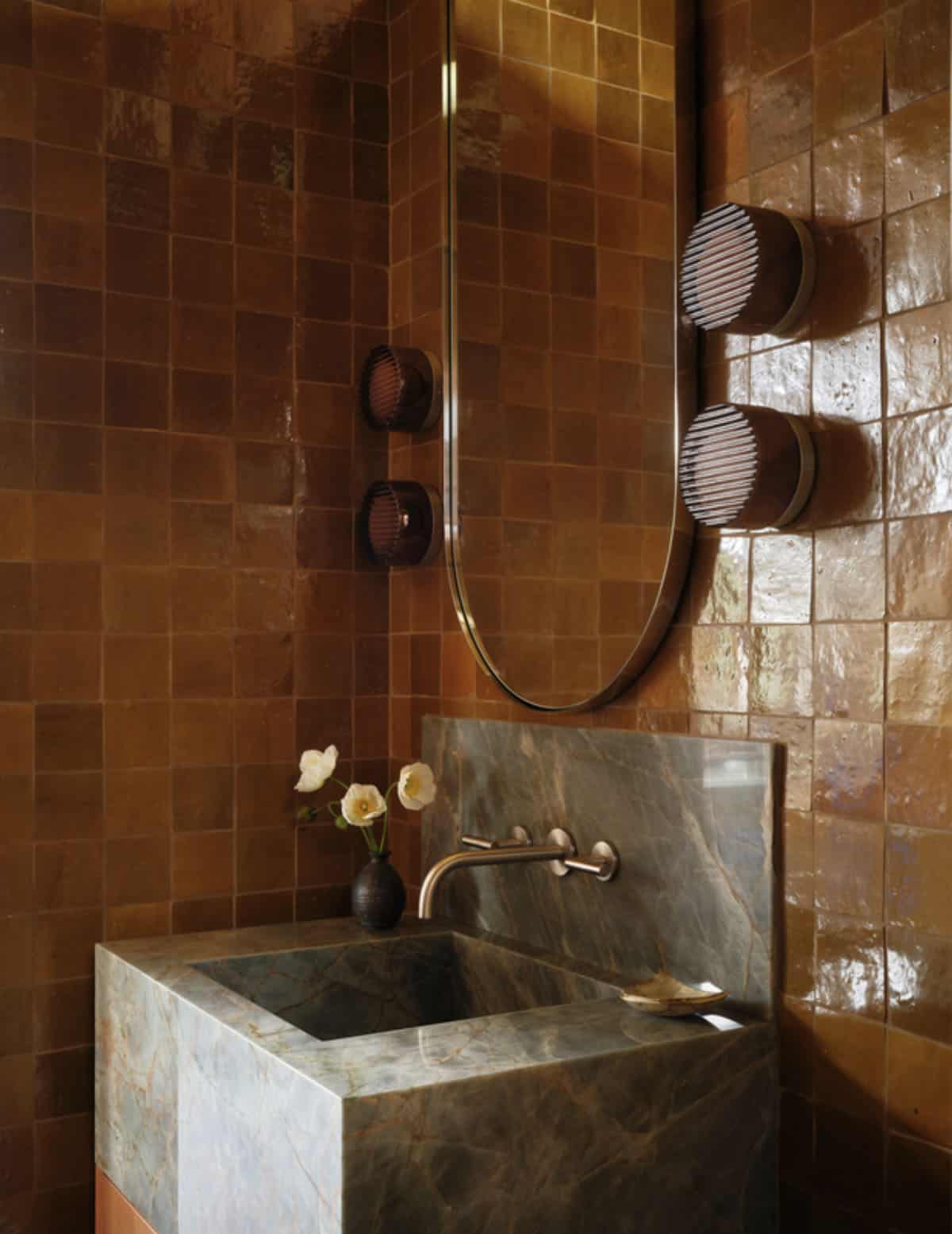 Powder room with glazed brown tile and green stone sink