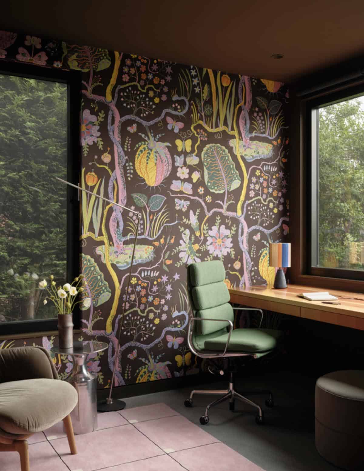 Home office with whimsical botanical wallpaper and green desk chair