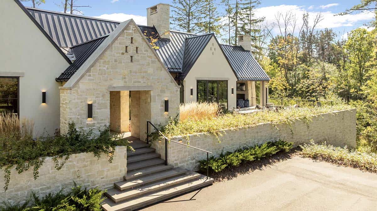 Side exterior view with stone chimney and covered patio fireplace