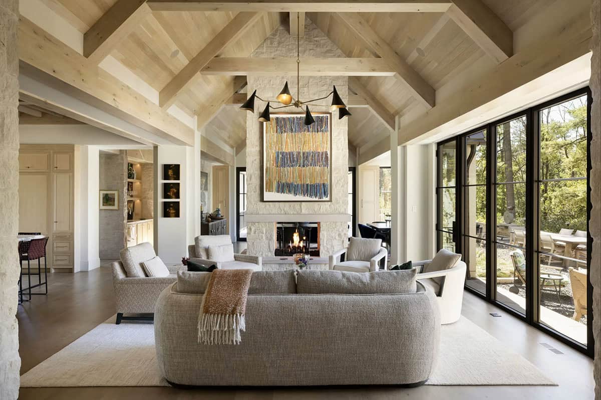 Vaulted living room with wood beams and stone fireplace art