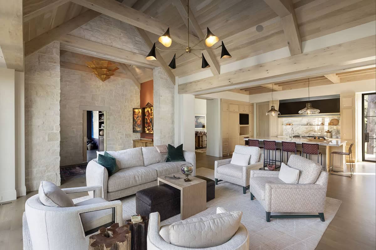 Open living room and kitchen with vaulted wood beam ceiling