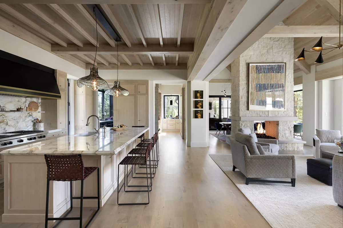Kitchen island with marble backsplash and view to living room