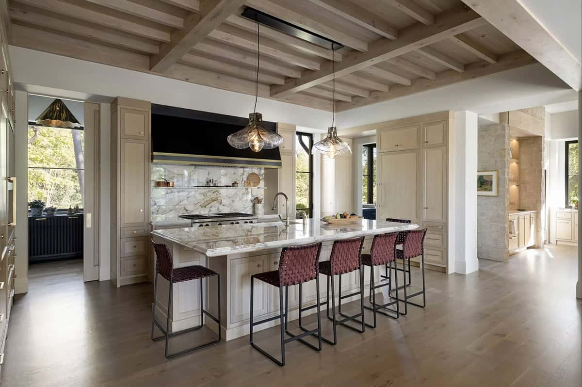 Kitchen with marble backsplash and glass bubble pendant lights