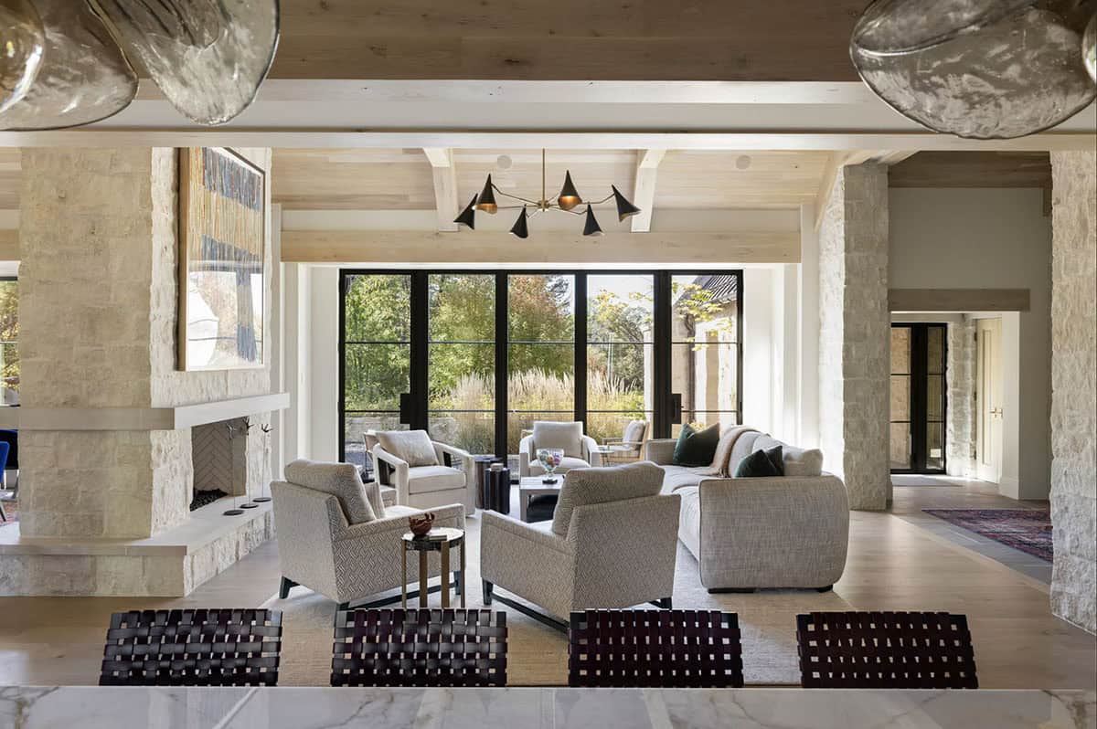 Living room seating area framed by stone columns and glass doors