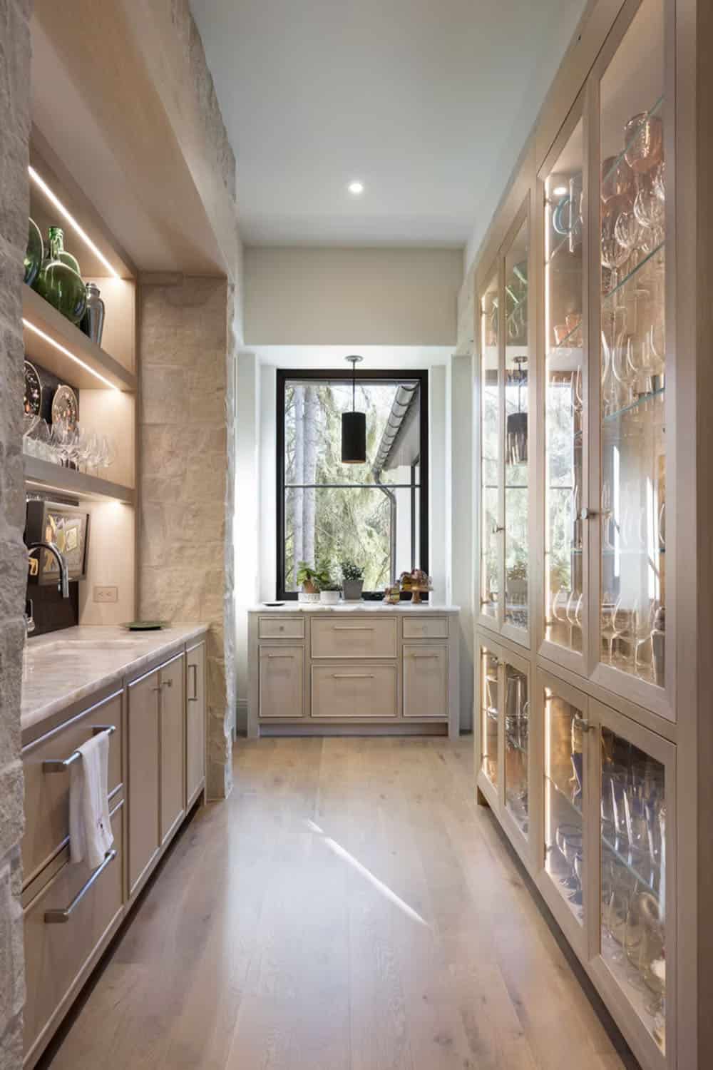 Butler's pantry with glass display cabinets and marble countertop