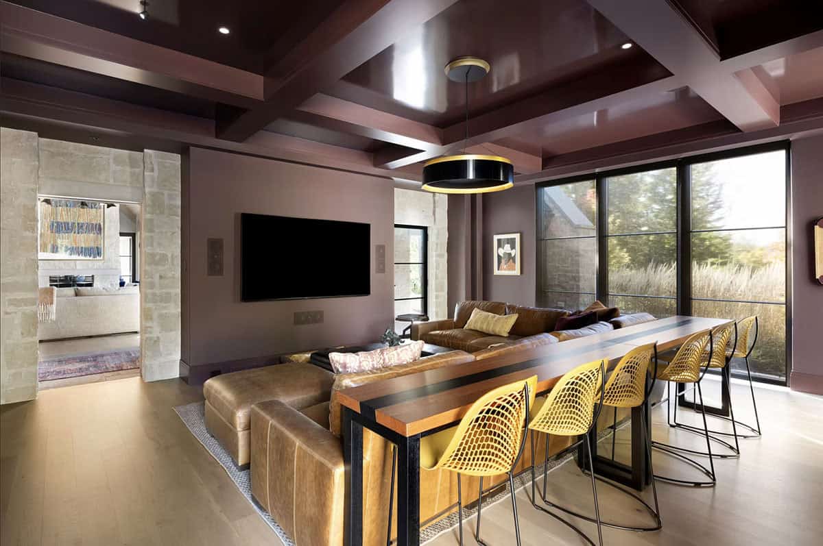 Media room with leather sofa and long bar-height table