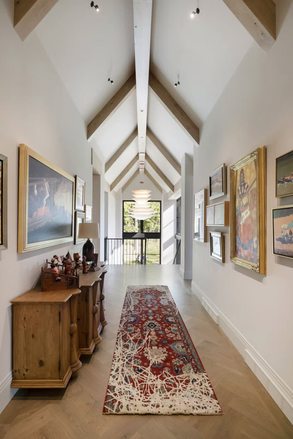 Gallery hallway with vintage art and patterned runner rug