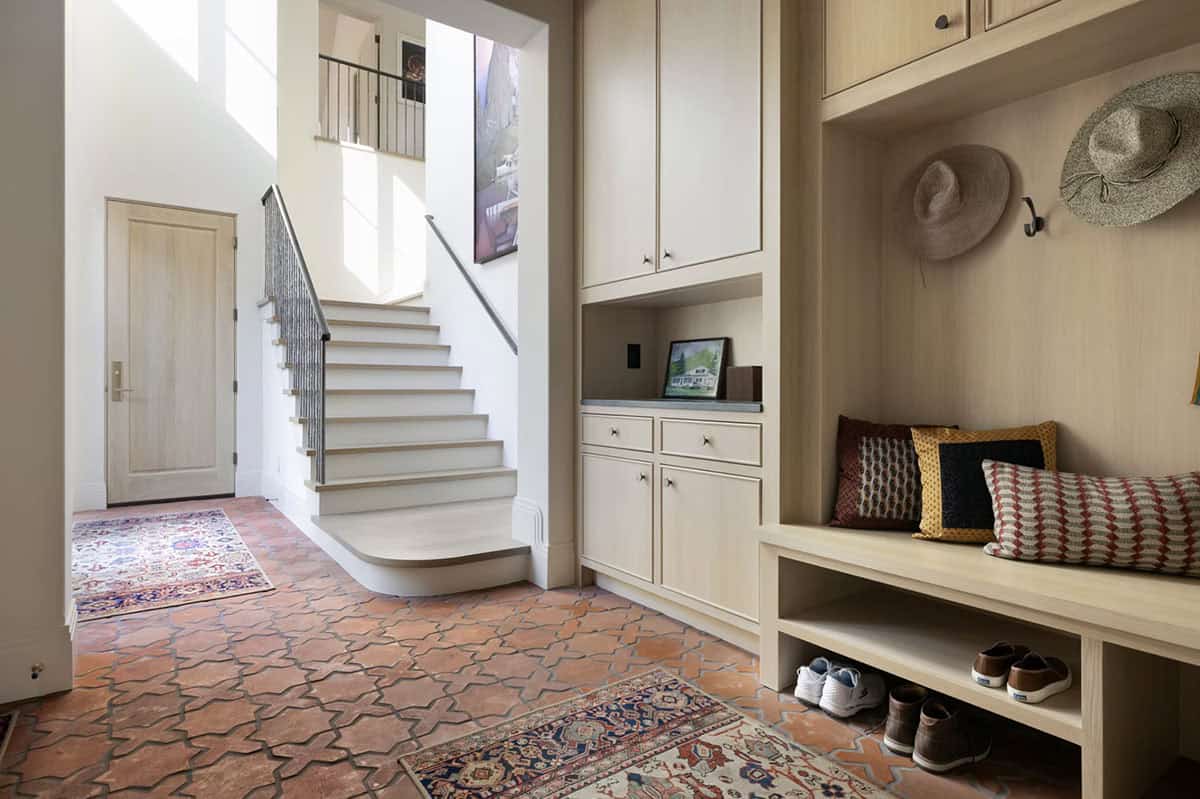 Mudroom entry with terracotta tile floor and built-in bench