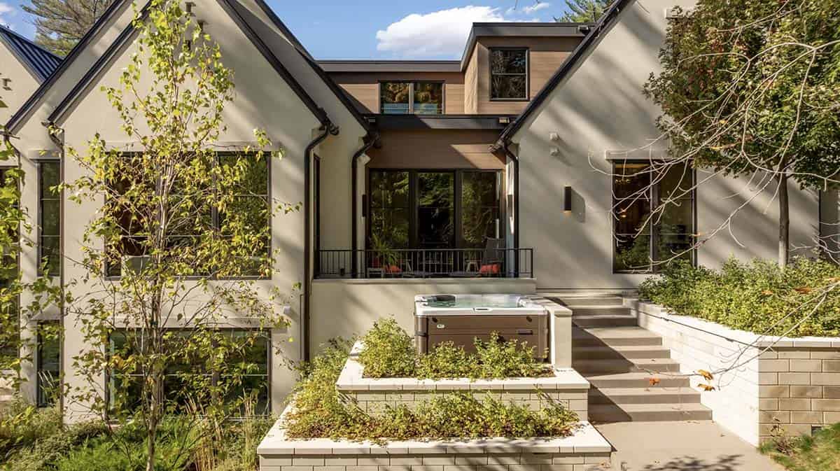 Modern rear addition with hot tub and gabled stone entr