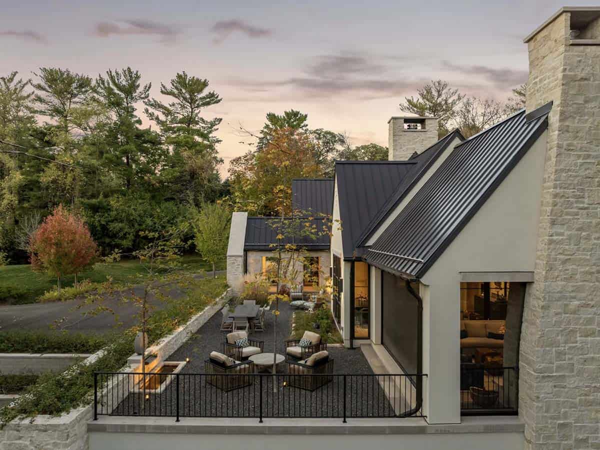 Aerial dusk view of stone terrace and gravel fire pit