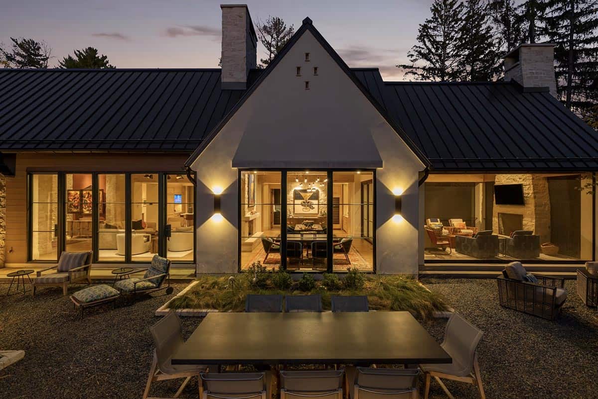 Dusk view of gabled dining wall lit from inside