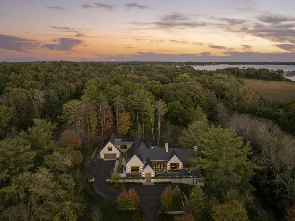Aerial dusk view of estate with distant lake visible