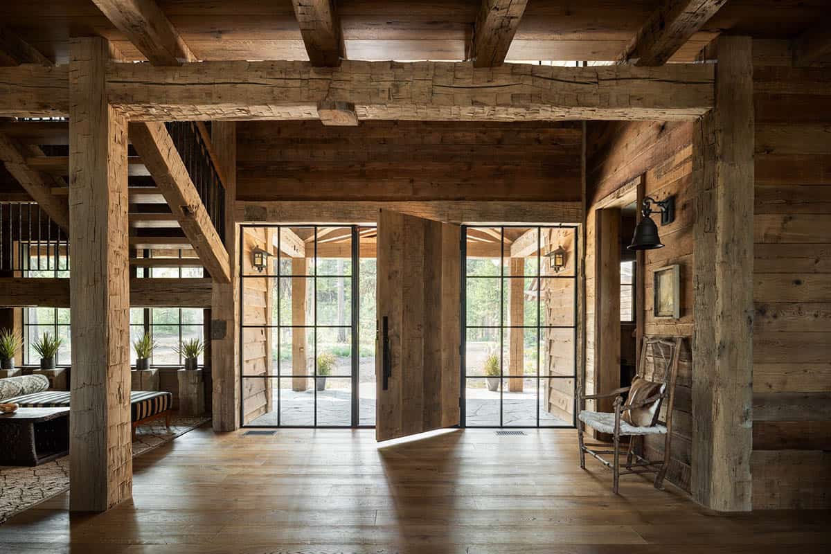 Entry with a pivoting wood front door between steel-framed glass panels