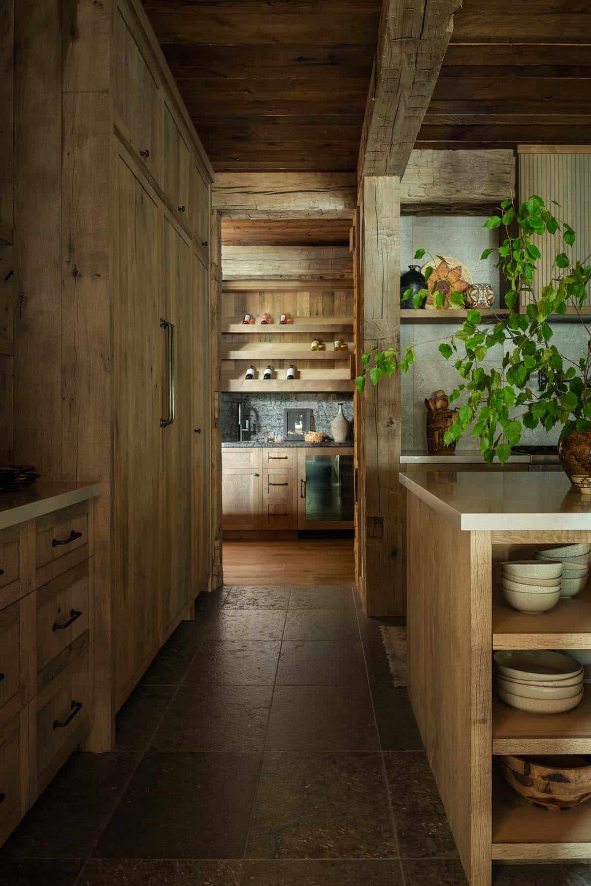 Kitchen passage with paneled refrigerator leading to a wet bar