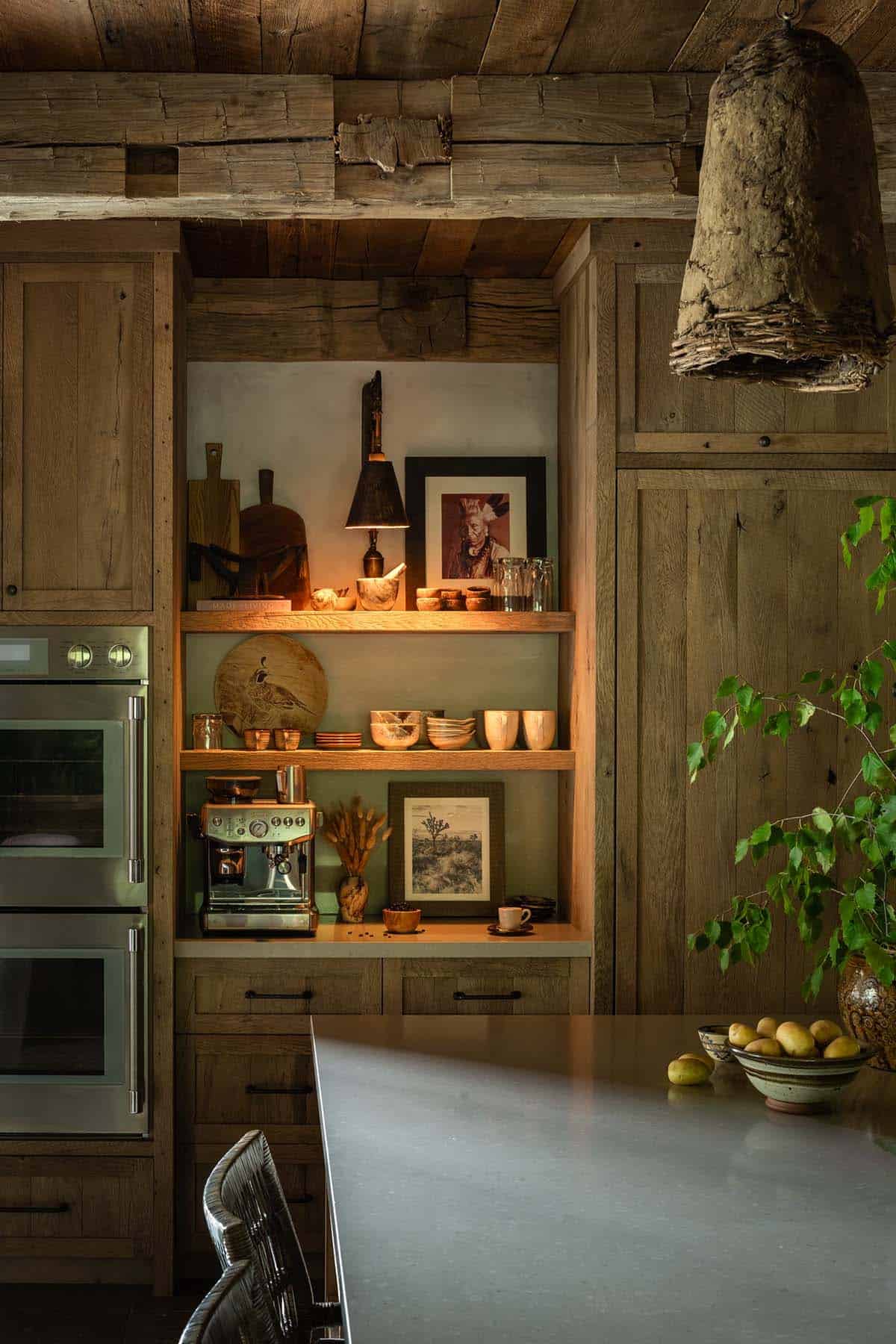 Coffee station with open shelves beside double wall ovens