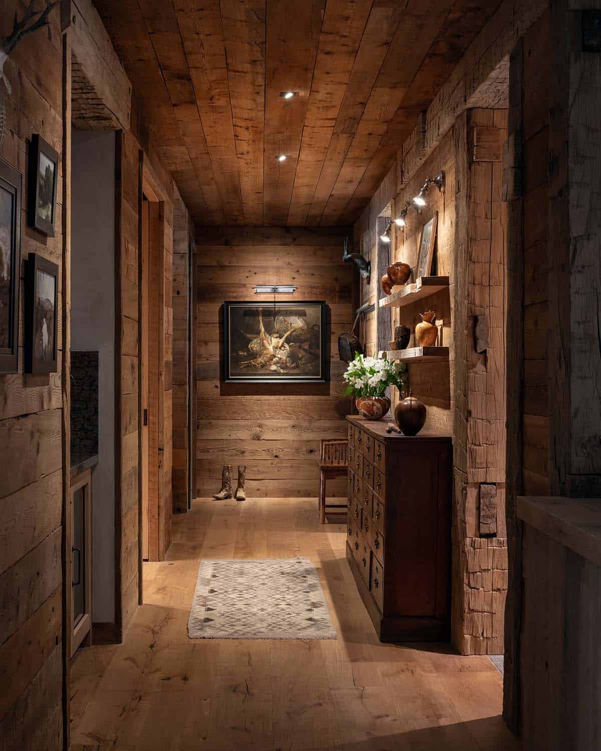 Hallway with apothecary chest, still life painting, and cowboy boots