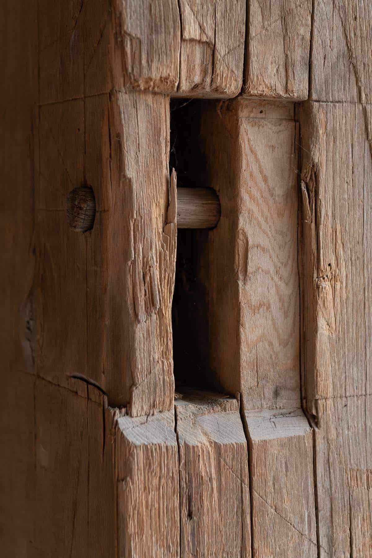 Wood peg joinery in a reclaimed timber post