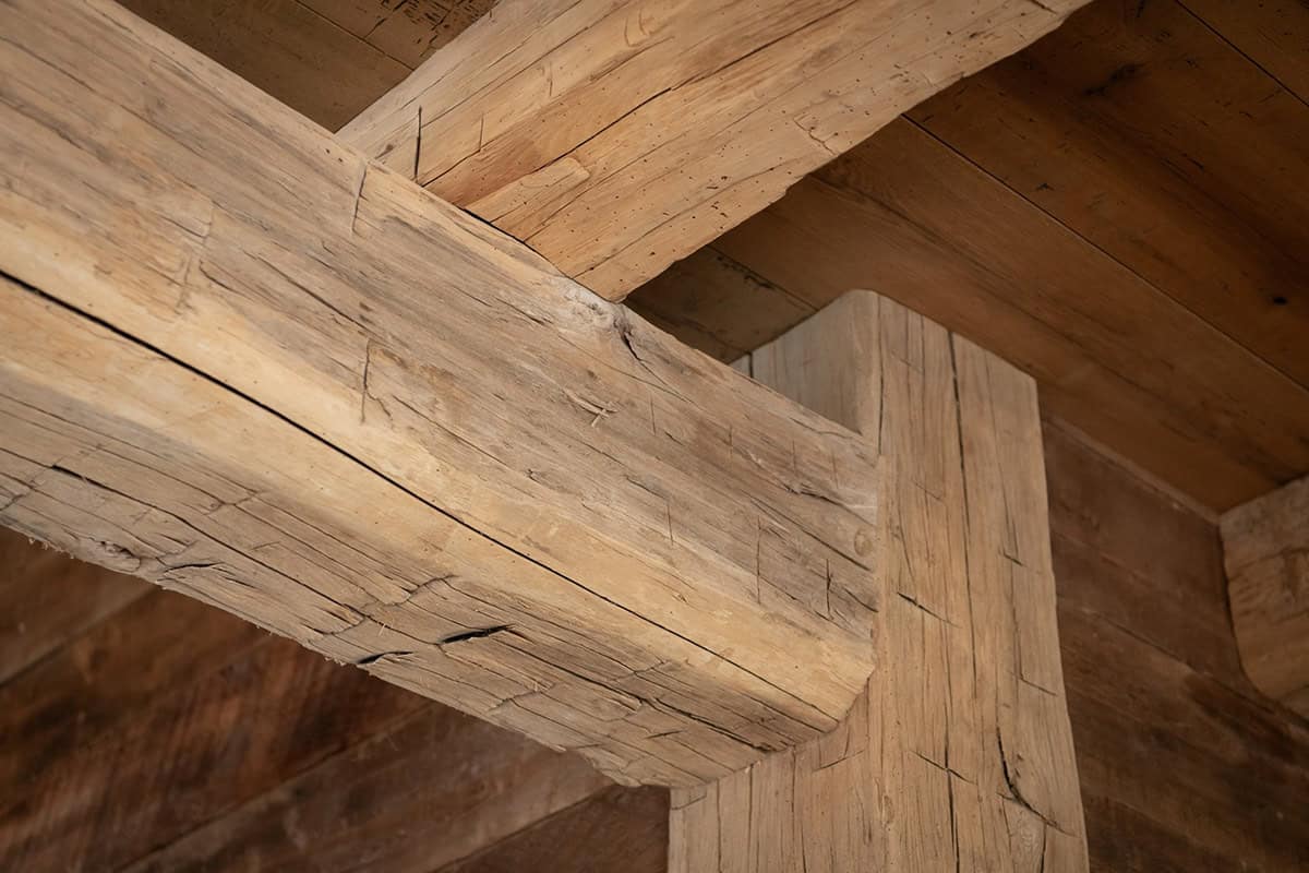 Hand-hewn ceiling beam meeting a timber post