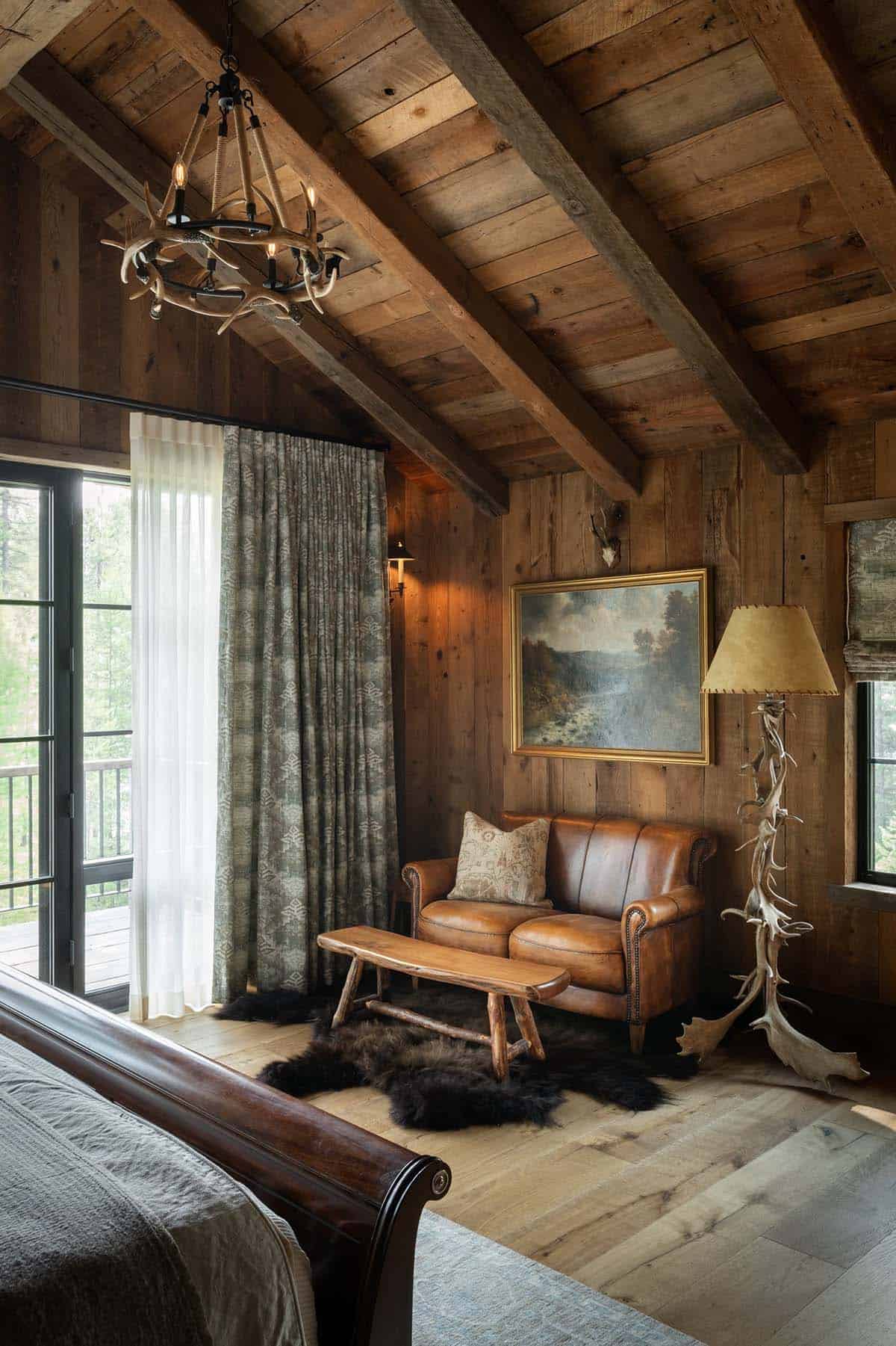 Bedroom corner with leather loveseat and antler floor lamp