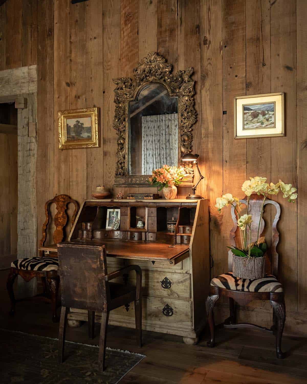 Antique secretary desk with gilded mirror and zebra-hide chairs
