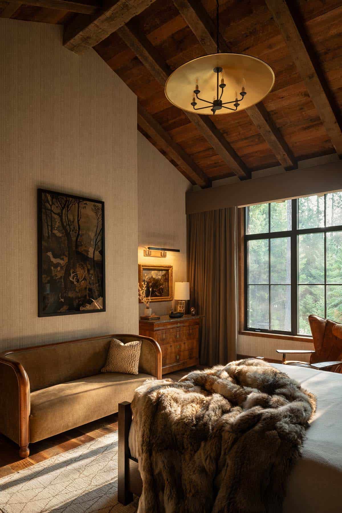 Bedroom with velvet settee, gold pendant, and forest painting