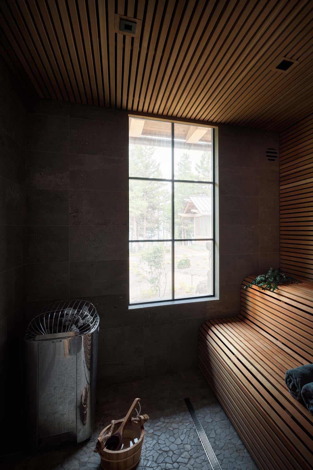 Sauna with curved cedar slat bench and tall window