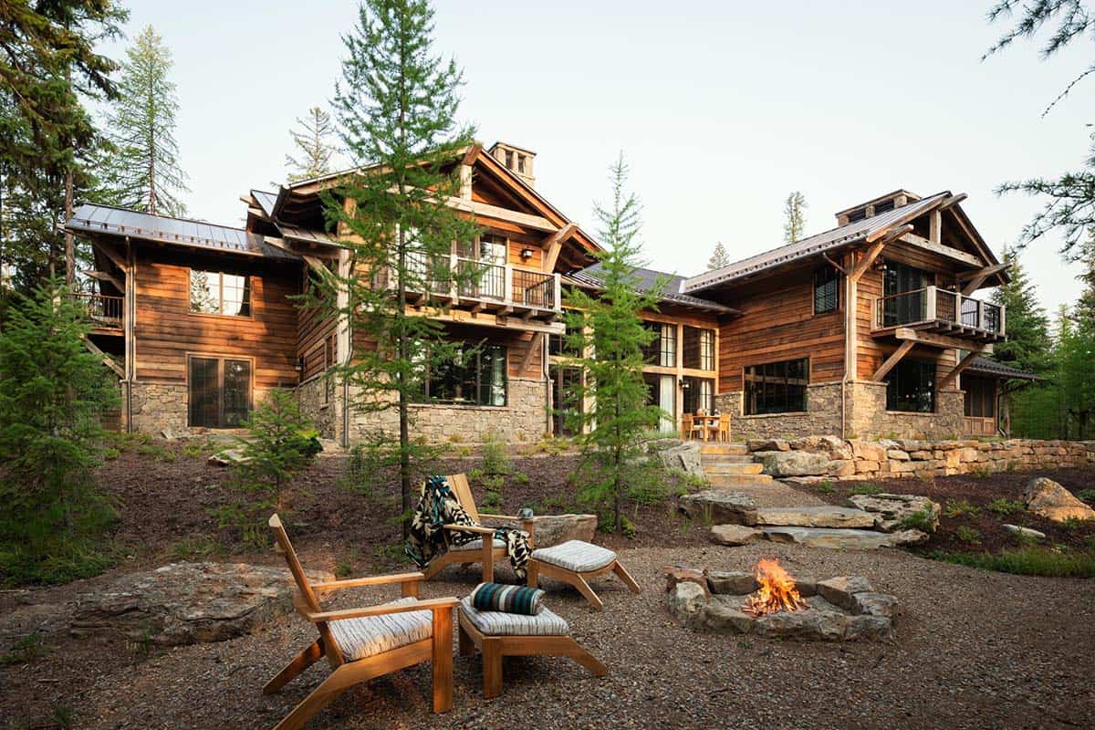 Backyard fire pit with teak chairs behind the lake house