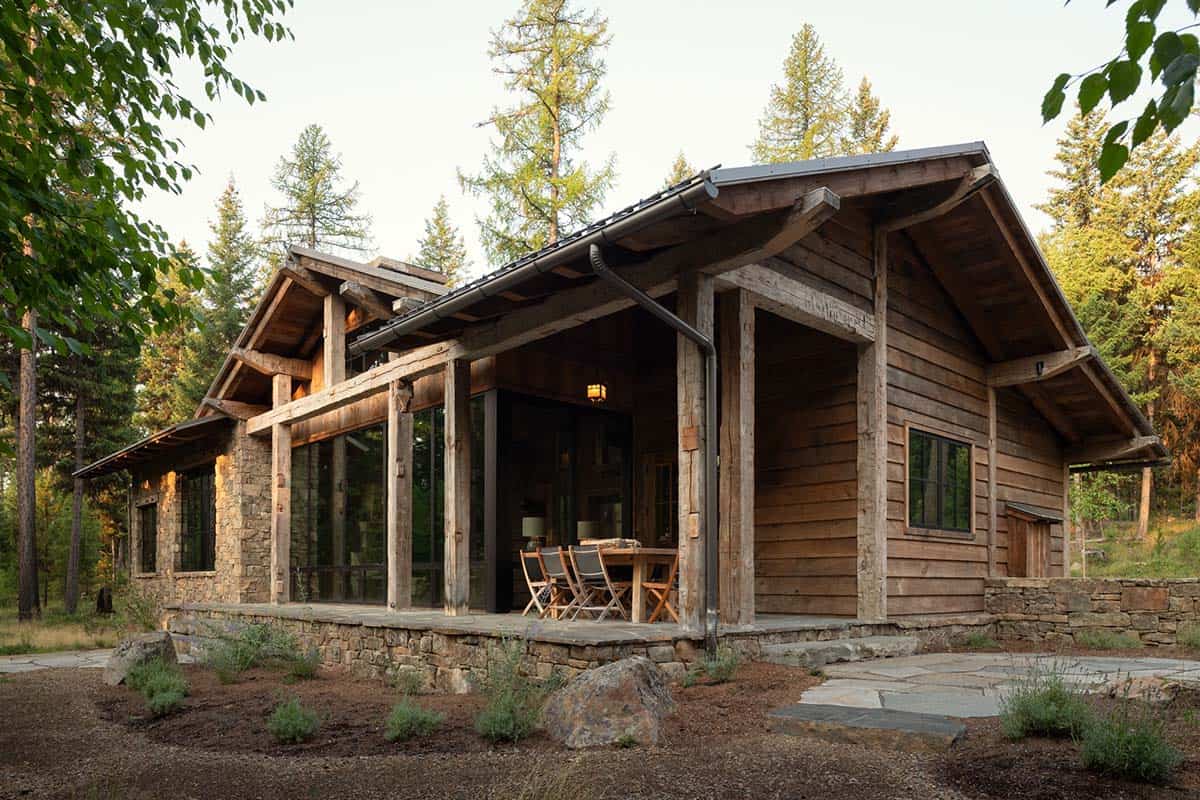 Guest cabin with covered porch, timber posts, and stone base
