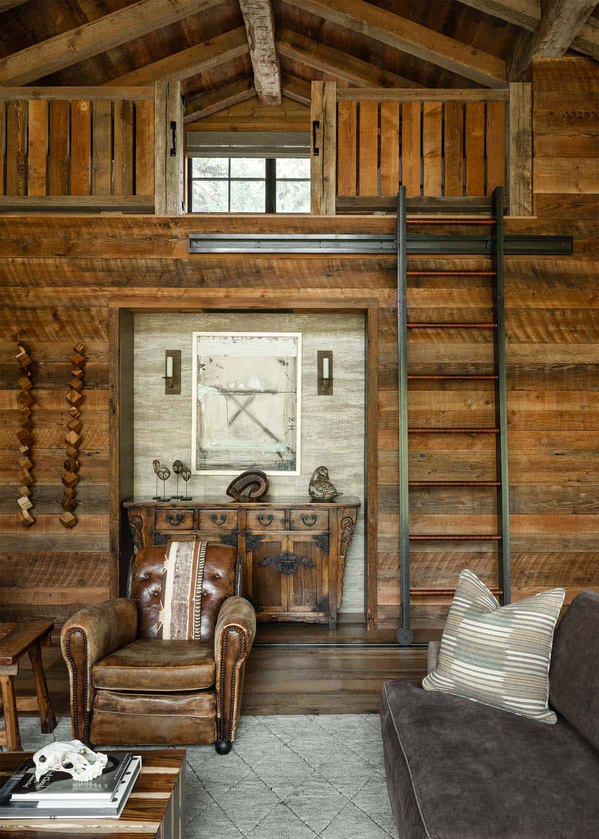 Guest cabin sleeping loft with a rolling library ladder