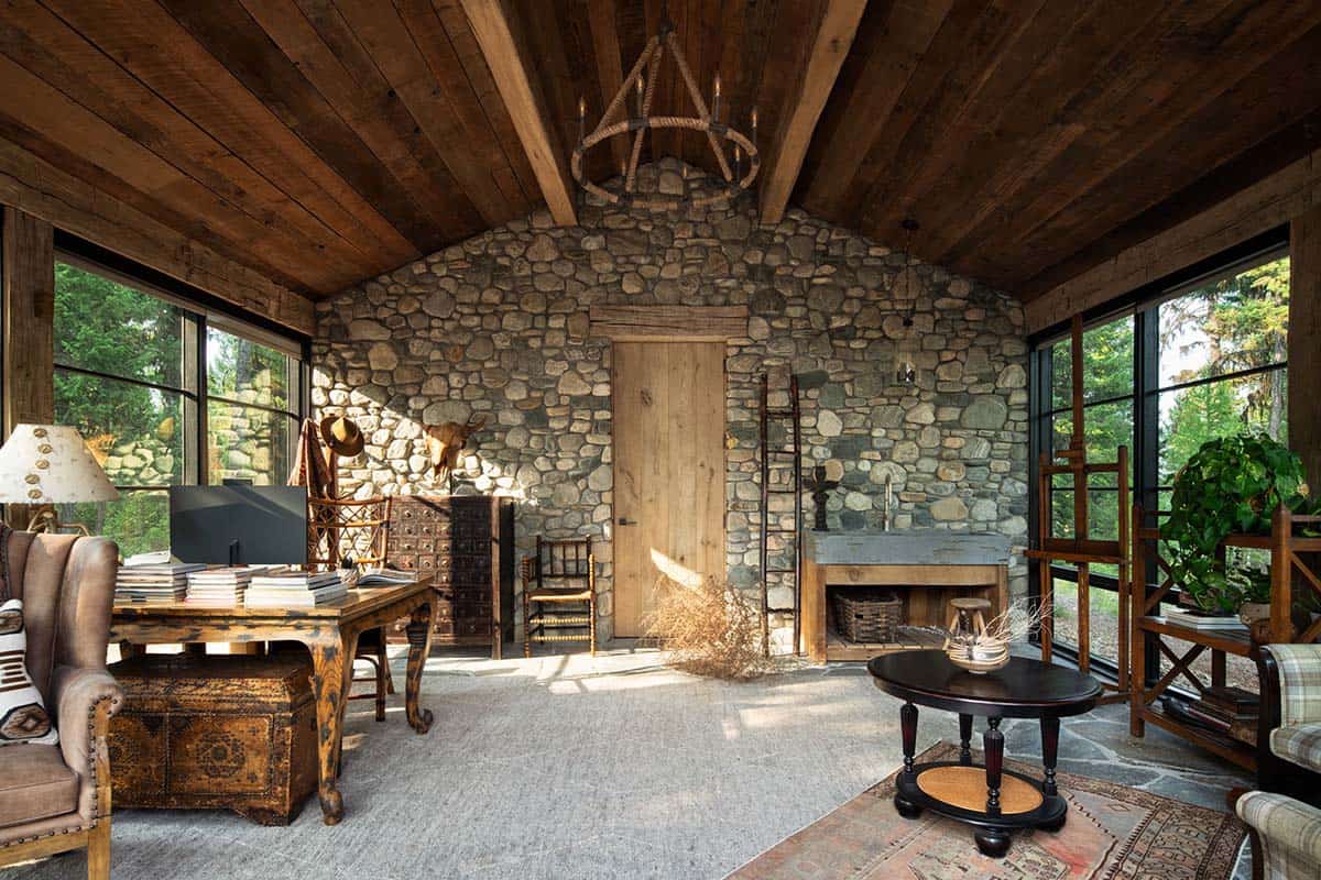 Art studio with river rock wall, easel, and work table