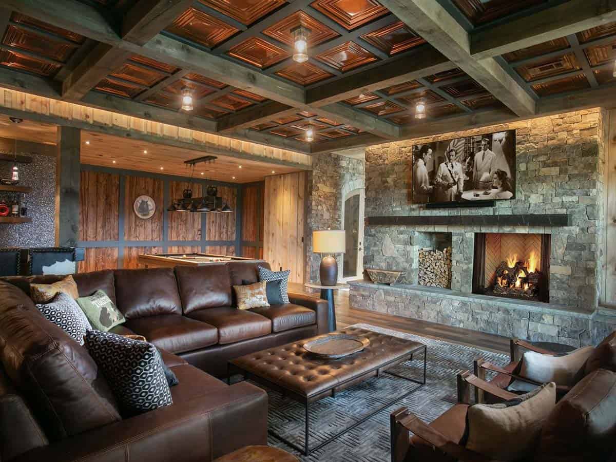 Family room with copper coffered ceiling, leather sectional and stone fireplace