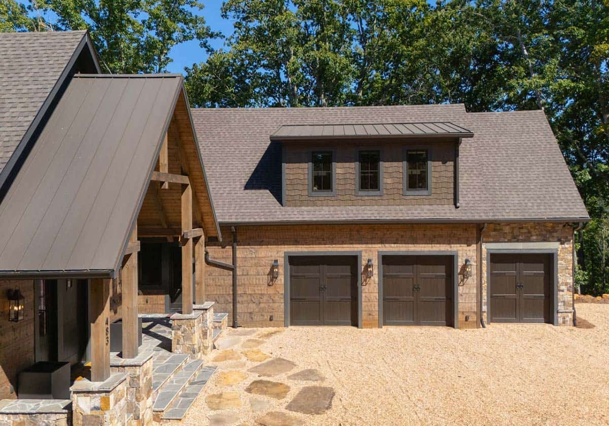 Three-car garage with shake dormer beside the timber entry porch