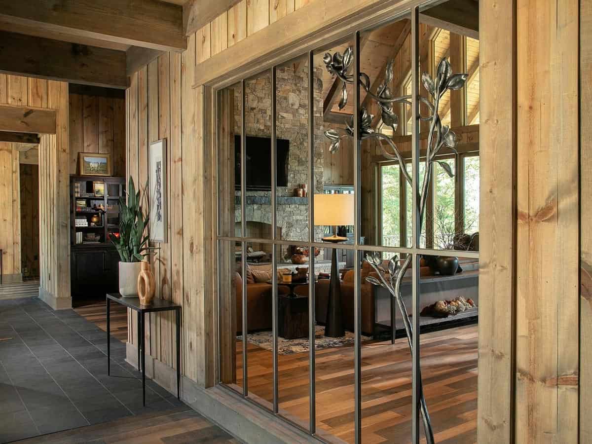 Steel grid divider with a metal dogwood tree looking into the great room