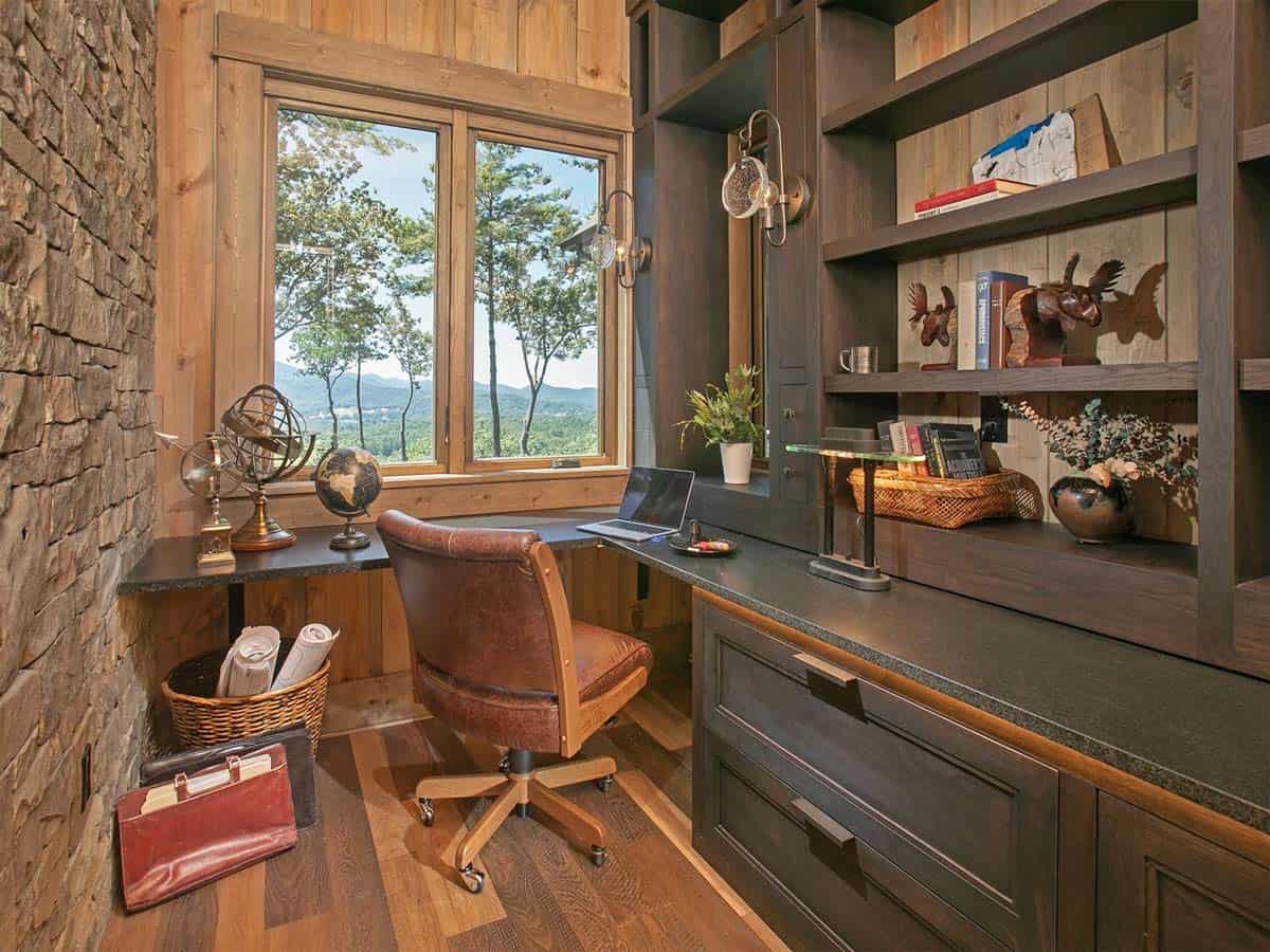 Home office nook with built-in desk, shelves and a mountain view window