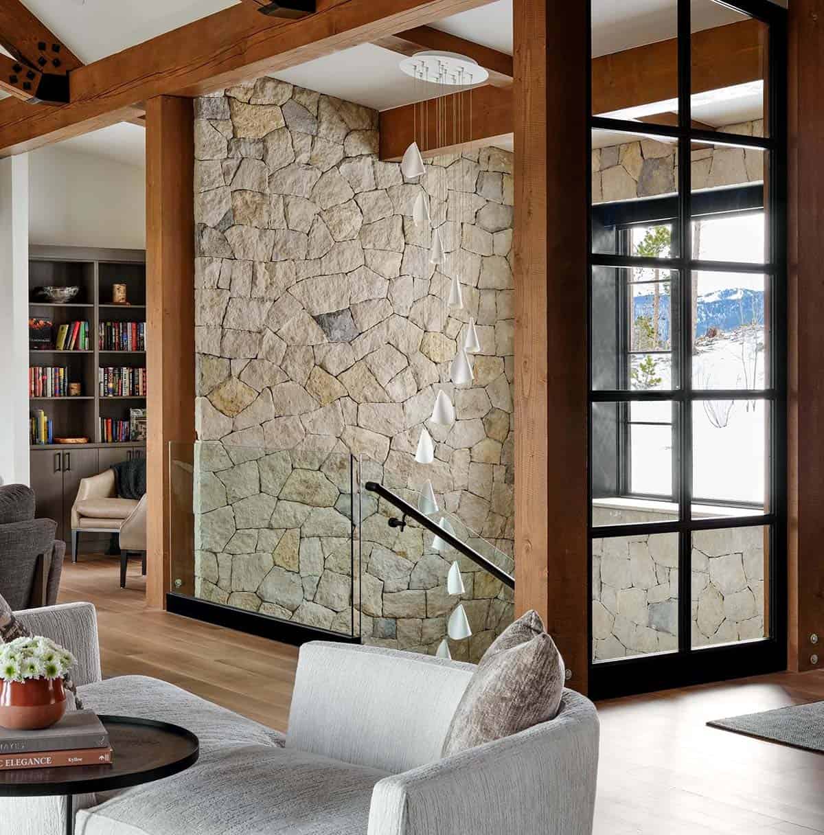 Stone stairwell with cascading white glass pendants and a glass railing