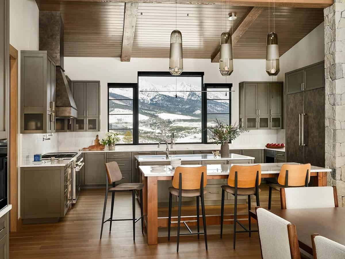 Kitchen with two islands and a window framing snowy mountain views