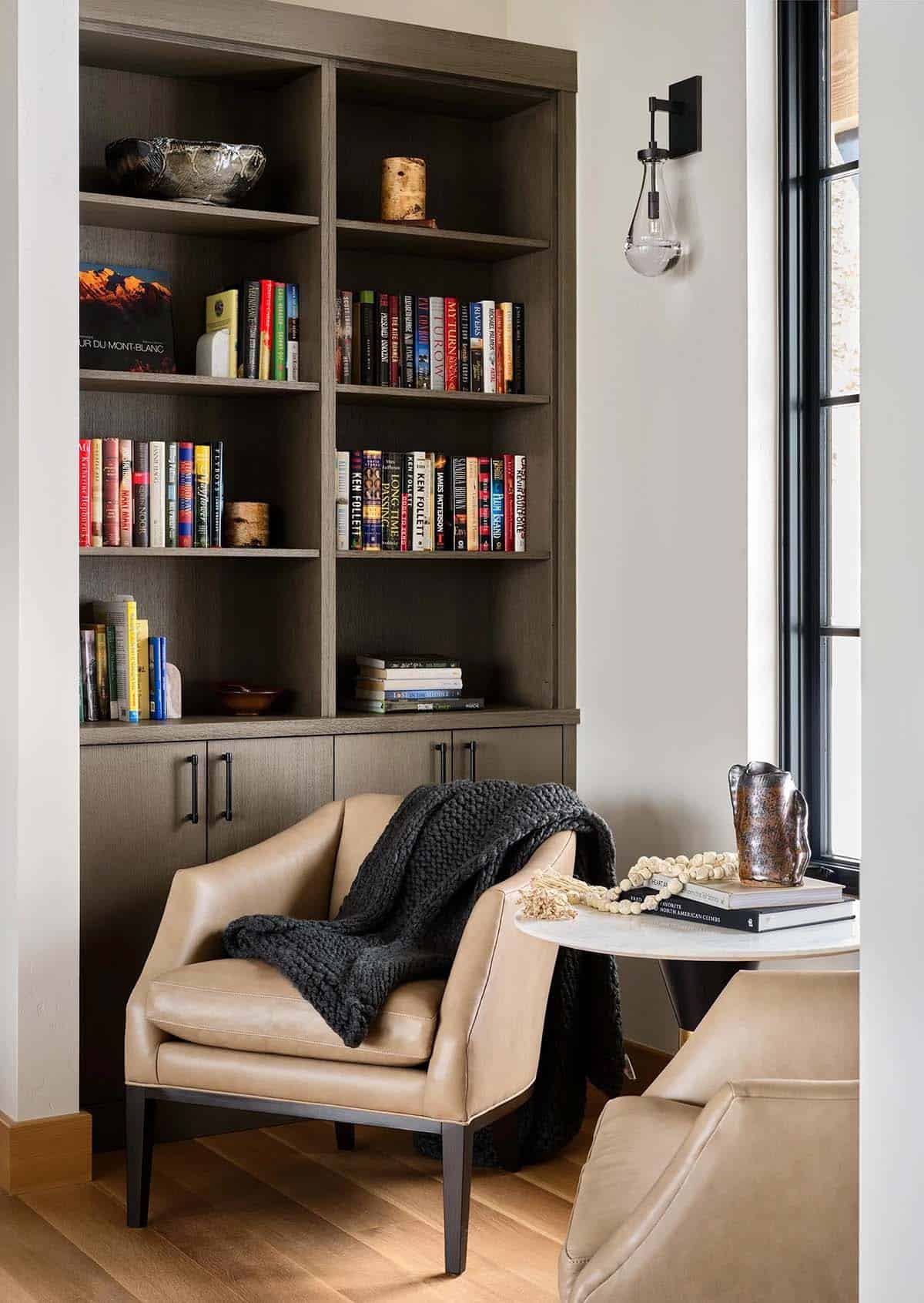 Reading nook with built-in bookshelves and leather armchairs