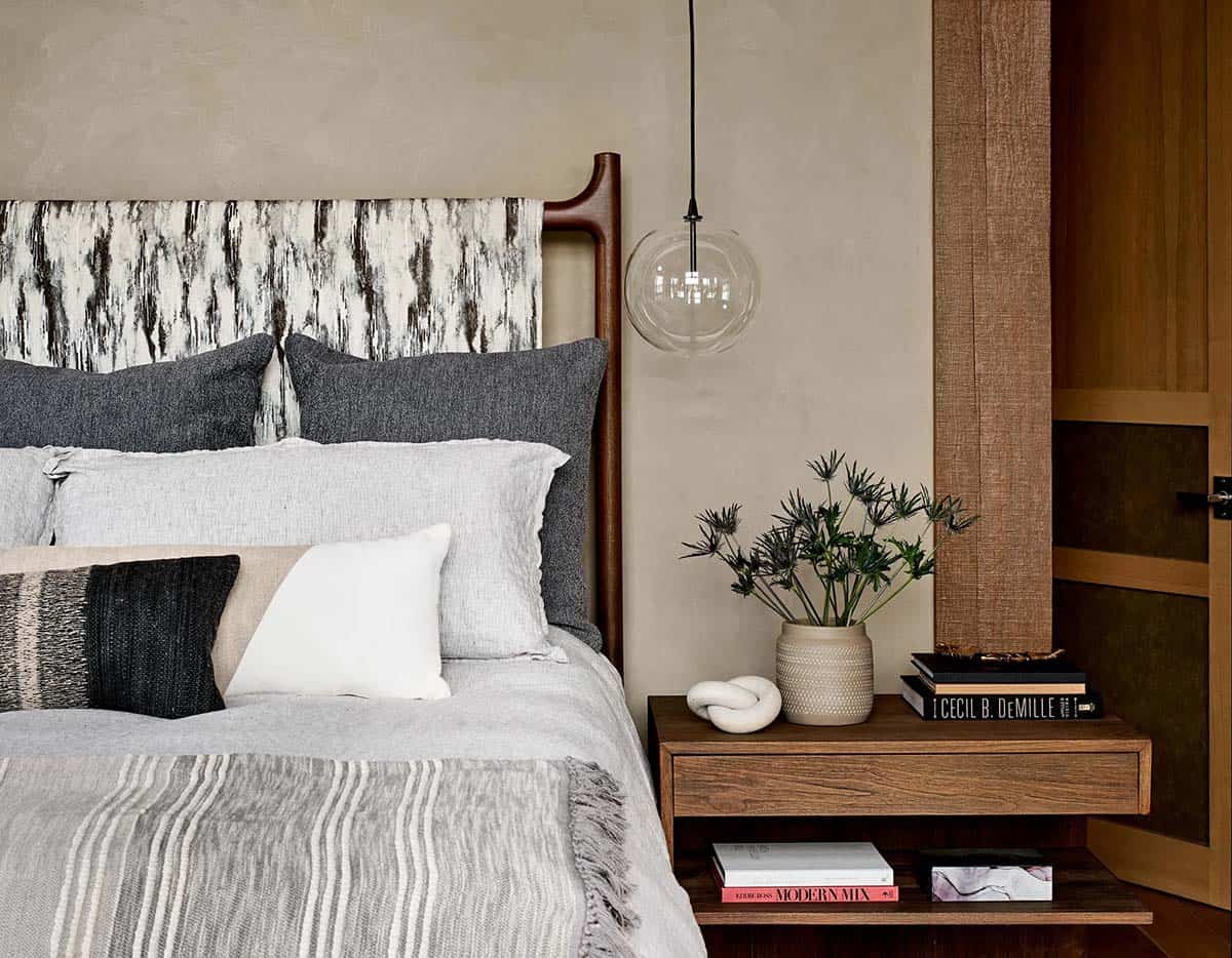 Primary bed with a birch print headboard and glass globe pendant