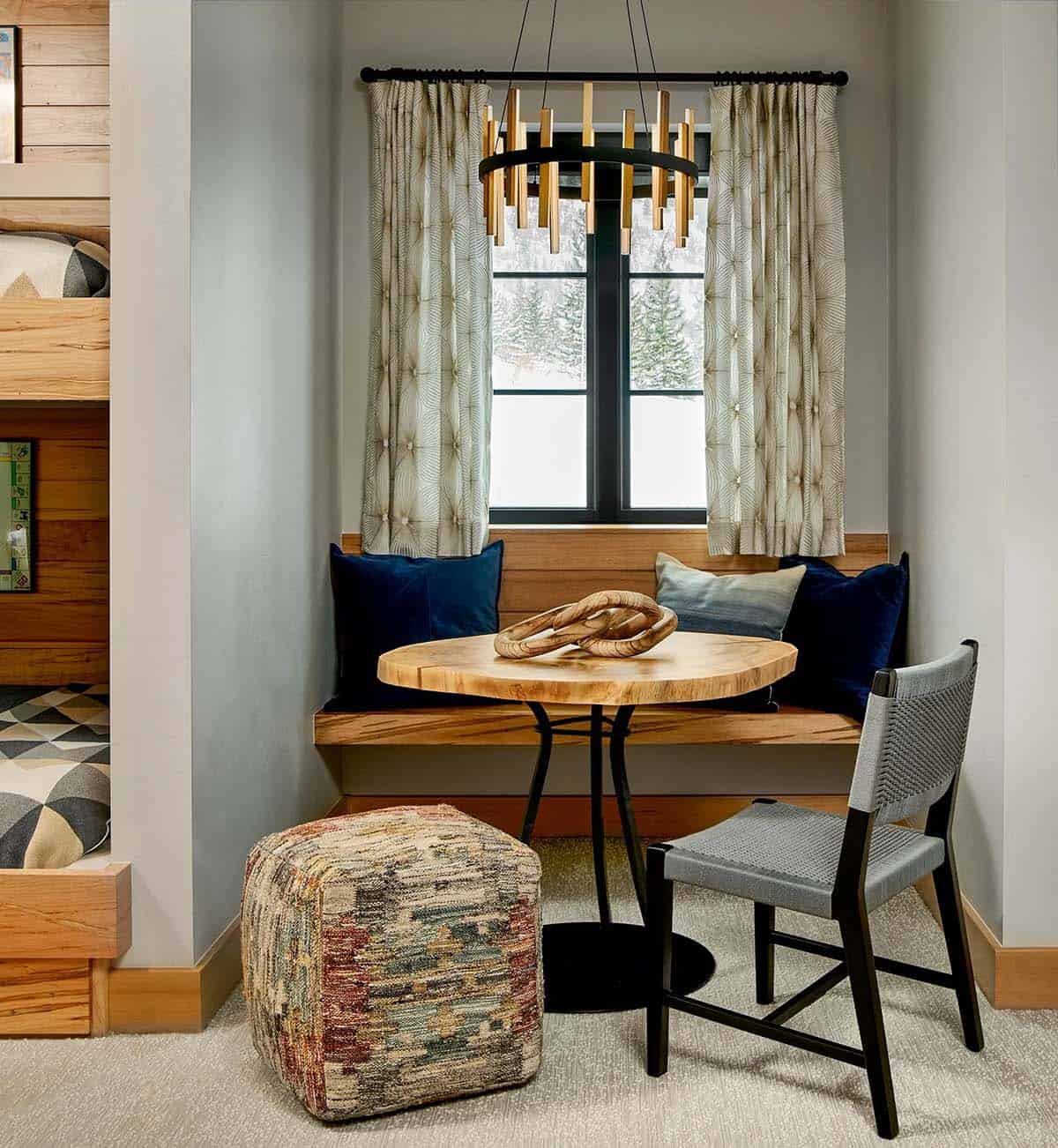 Bunk room window nook with built-in bench and live-edge table