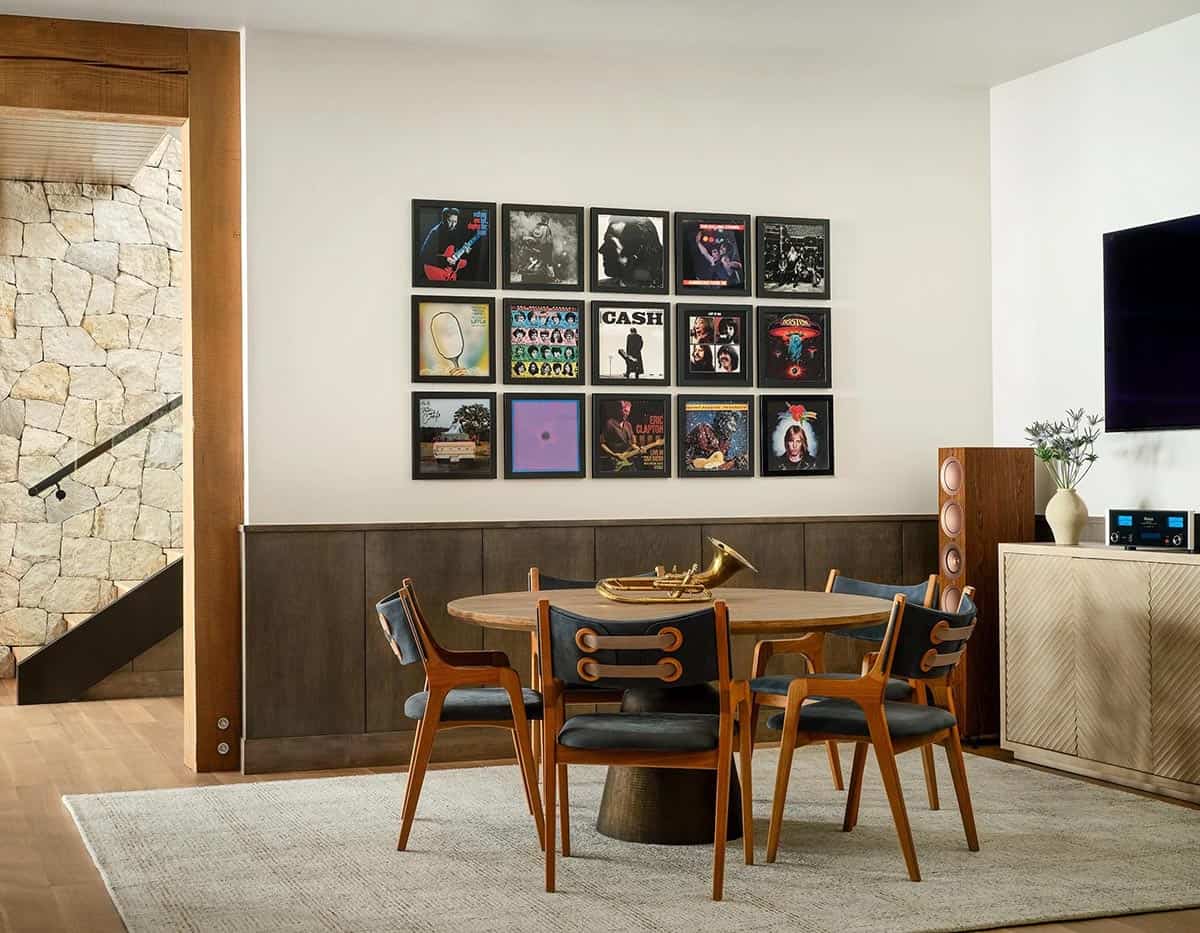 Music room with framed album covers above a round dining table