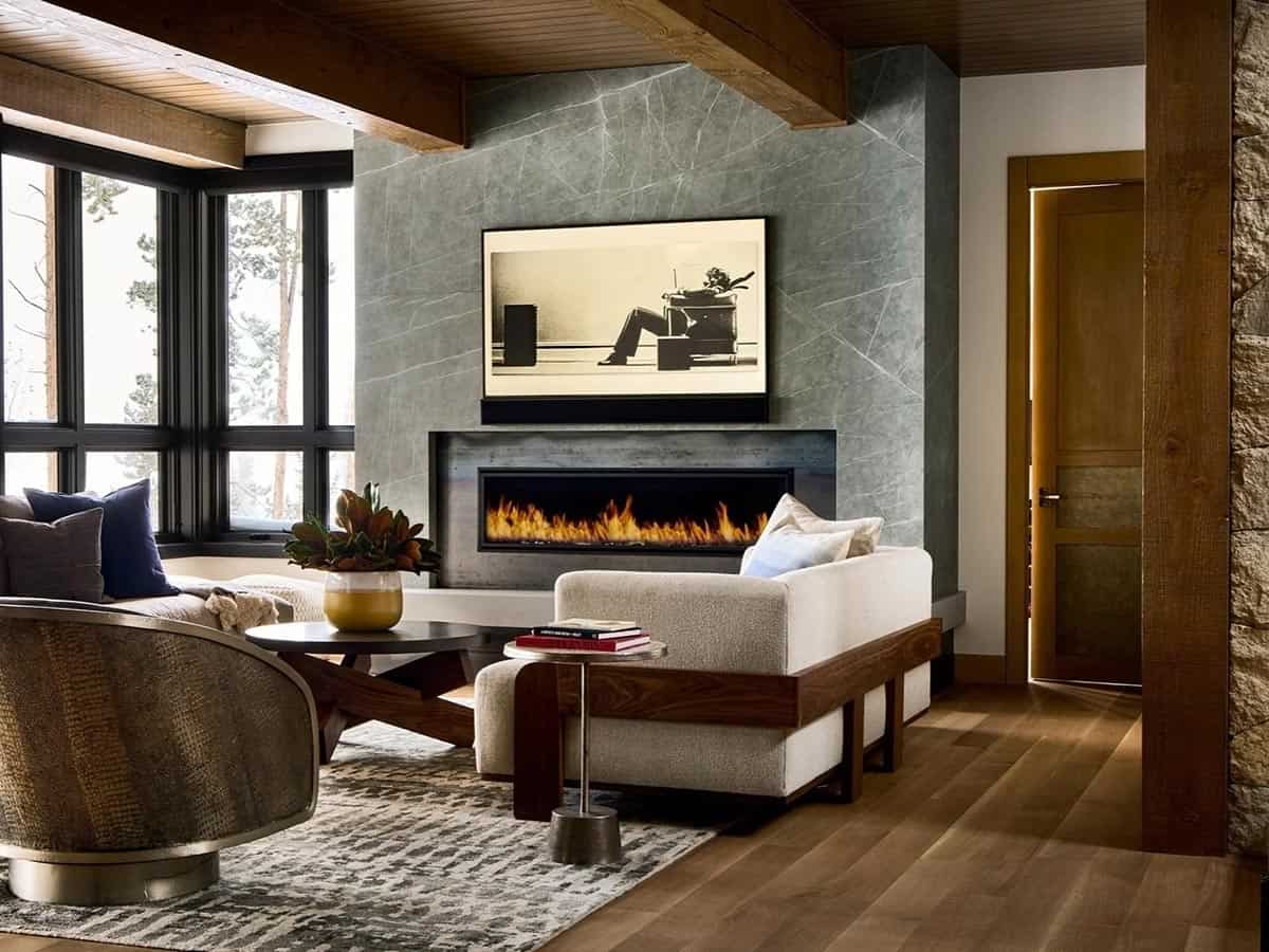 Family room with linear fireplace, gray stone wall, and white sofa