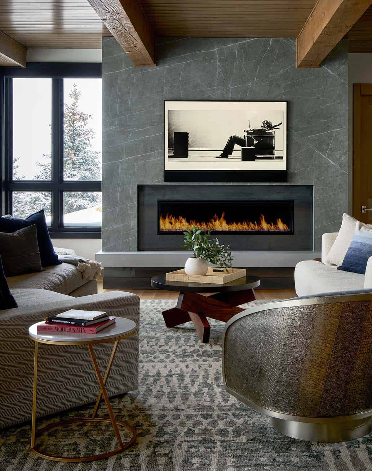 Family room with a Blown Away print above a linear gas fireplace
