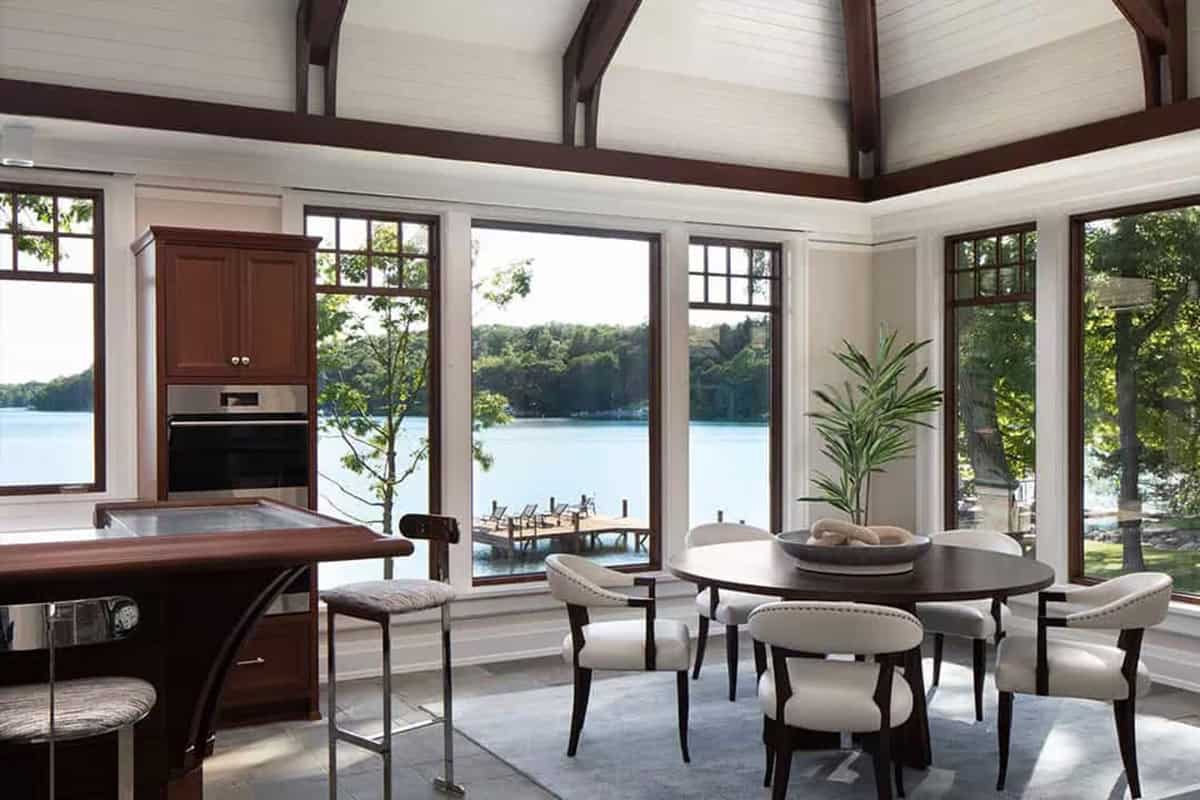 Boathouse kitchenette and round dining table with lake views