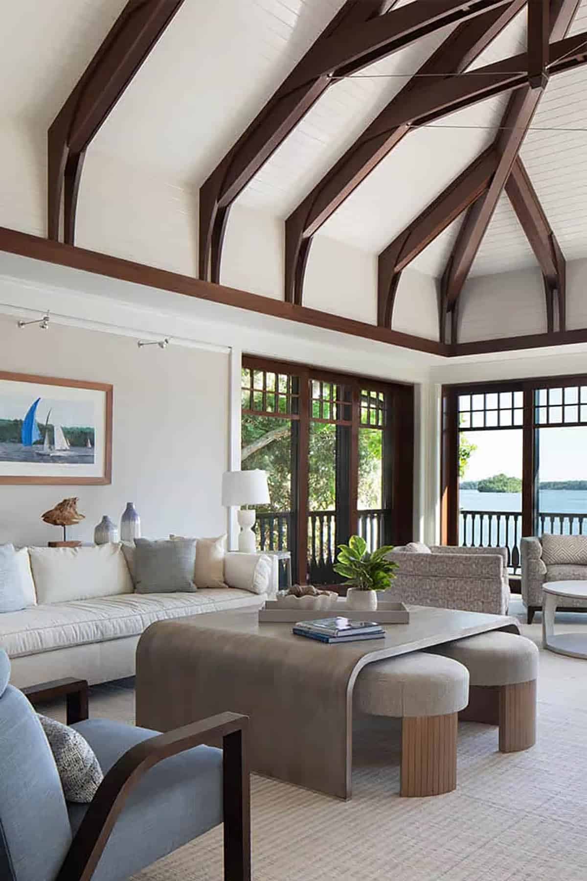 Boathouse living room with timber trusses and sailboat artwork