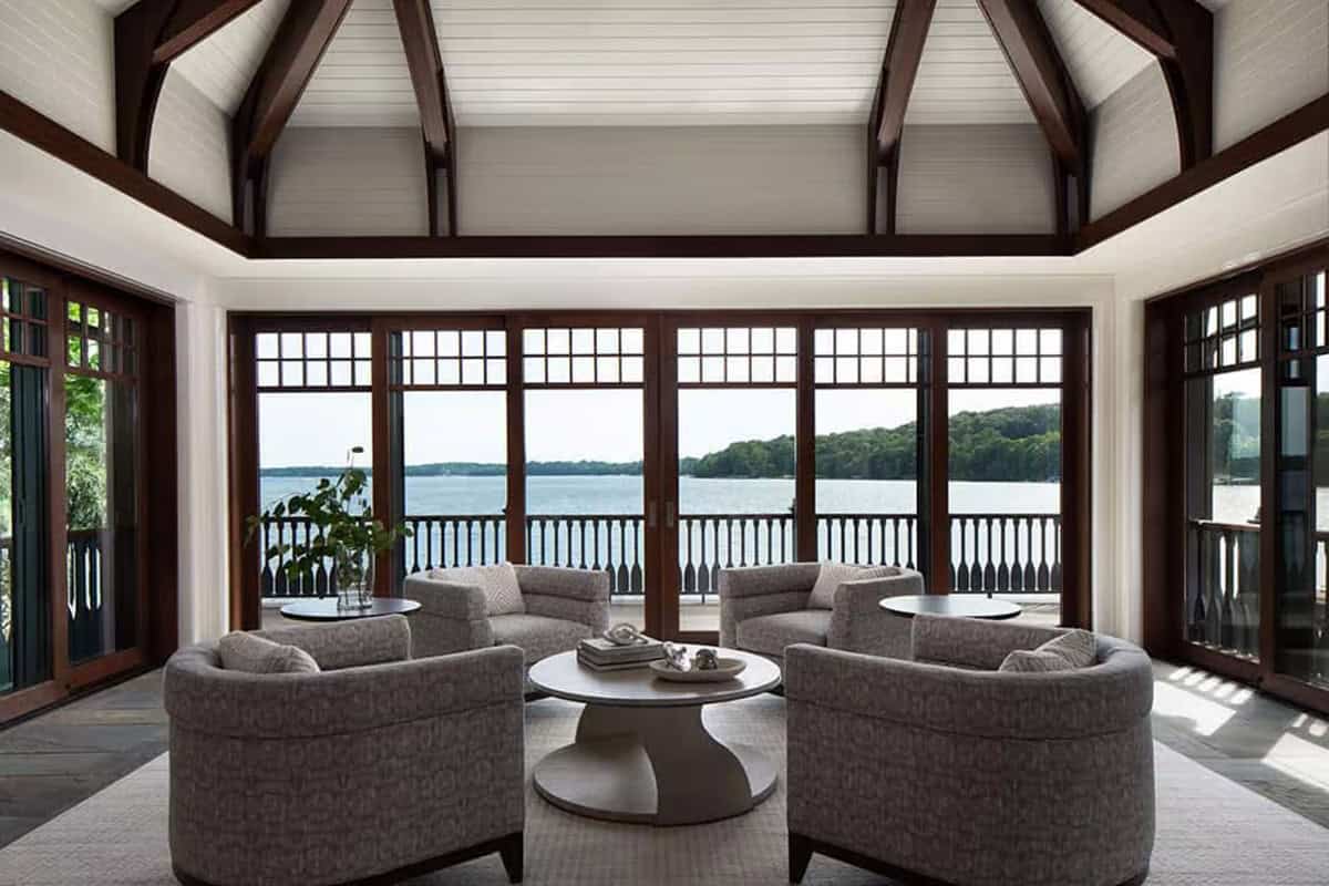Boathouse sitting room with four chairs facing lake doors